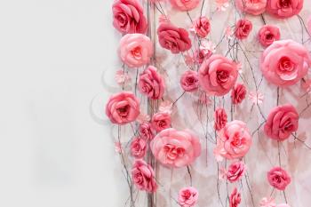 Many artificial decoratory roses on the wires