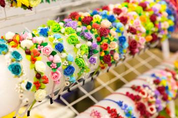 Beautiful bright chaplets with flowers in the shop