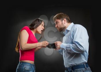 Woman and man looking for money in an empty wallet
