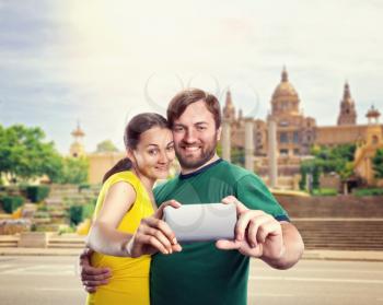 Happy man and woman making selfie in the summer park
