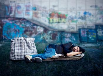 Homeless sleeping on the cardboard on the street