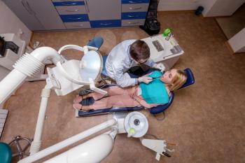 Top view of young woman seeing a dentist