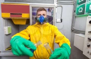 Man in protective suit working with tubes while cooking meth