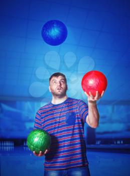 Man juggling with bowling balls
