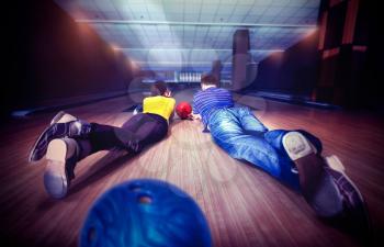 Couple lying on the floor in bowling