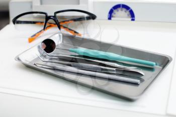 Dentist instruments and protective eyeglasses on the table