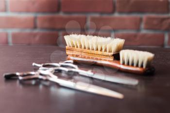 Close up of barber's tools on the table over brick wall