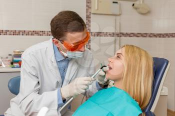 Portrait of dentist working with young woman