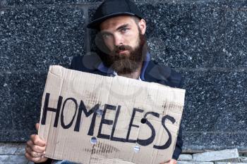 Homeless sitting with piece of cardboard