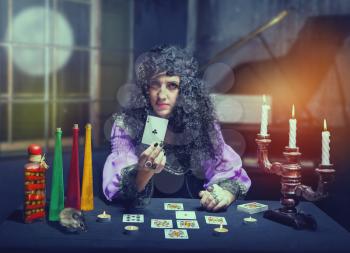 Sorceress telling fortunes using cards, she shows holeinone