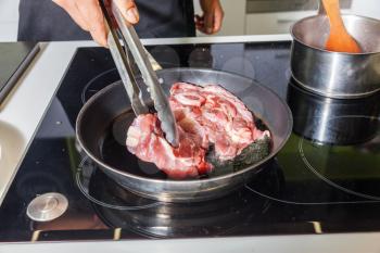 Raw meat on the frying pan