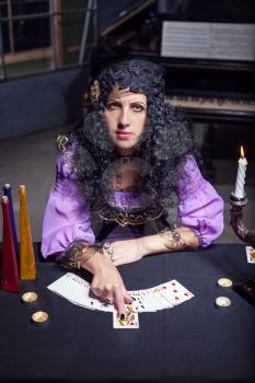 Close up of sorceress telling fortunes using cards