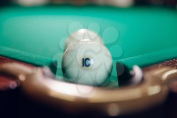 Two white billiard balls near the pocket focused