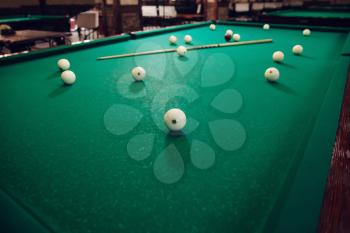 Billiard able with balls and stick on it