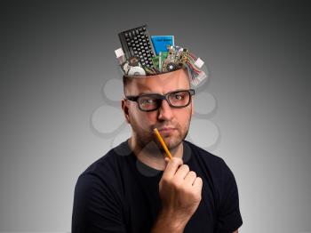 Man with computer details in the head holding a pencil