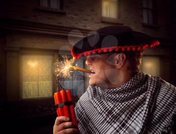 Side view of man in sombrero firing dynamite with a cigar near the building