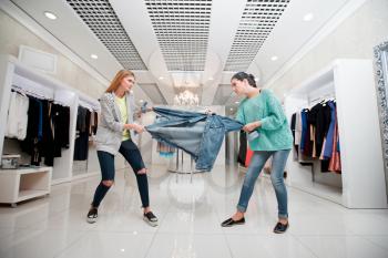 Young women fighting for a jacket in the shop