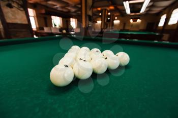 View of cue balls on the green table