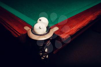 Two white billiard balls near the pocket focused