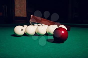 Billiard items on the table: balls, stick and triangle