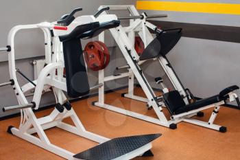Side view of white modern sport machines in the gym