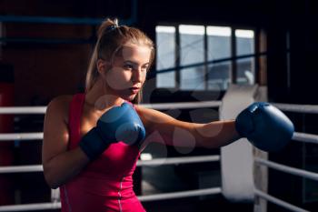 Portrait of young woman boxing