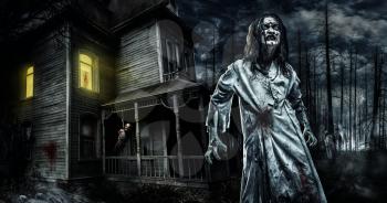 Scary zombie near the abandoned house. Horror. Halloween