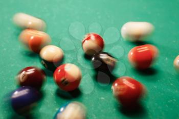 Spheres scatter on a billiard table. Green cloth. 