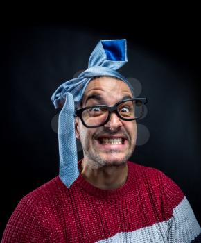 Crazy man with tie on his head  having fun on corporate christmas party. Office and corporate party concept.