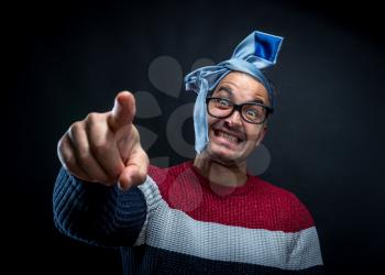 Portrait of drunken man in sweater with blue tie on his head isolated on black background. Office and corporate party concept.