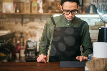 Barman making check in cafe