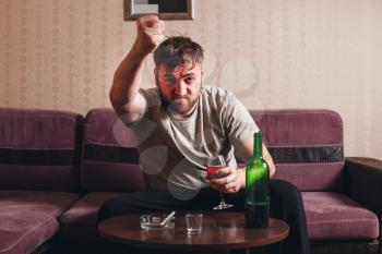 Angry drunk man in depression. Alcohol abuse problems.