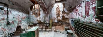 Prison interior with grunge rusty round ceiling and brick walls. Panorama view.
