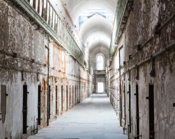 Old prison interior with grunge brick walls.
