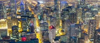  Illuminated skyscraper buildings in steel, concrete and glass, night view, Chicago, Illinois USA.