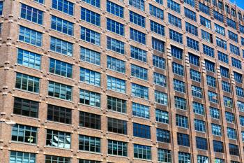 Facade of brick building with wooden windows. Cityscape modern art