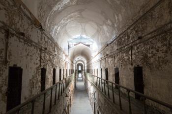 Old prison interior with grunge brick walls.