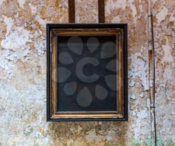 Empty frame from an icon on grunge brick wall of prison cell.