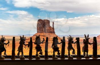 Silhouettes of figures of Indians with Monument Valley National Tribal Park on background, Navajo, Utah USA