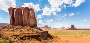 Scenic formations of red sandstone mountains at Monument Valley National Tribal Park, Navajo, Utah USA