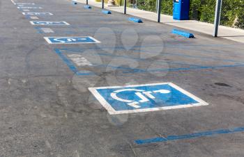 Blue and white handicap symbols on parking space.