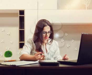 Female bookkeeper in glasses working at the table. Accountant at workplace concept