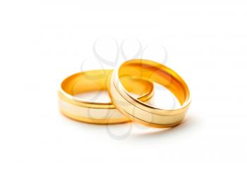 Pair golden wedding rings isolated on white background