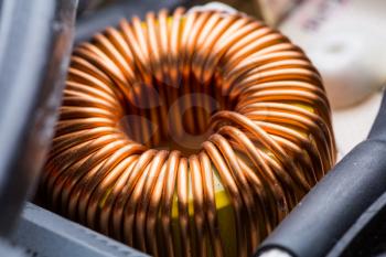 Electric transformer copper coil closeup. Electrical component