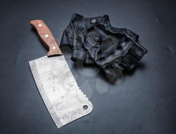Meat cleaver and fingerless leather gloves isolated on black background. Instrument collection of bloody killer maniac