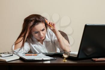 Tired young woman accountant at workplace concept.  Female bookkeeper at the office