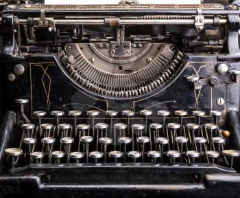 Retro grunge black typewriter closeup. Antique type writer
