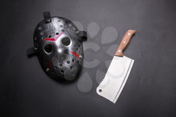 Crazy psycho man instruments isolated on black background. Hockey mask with bloody strips and meat cleaver. Serial murderer tools