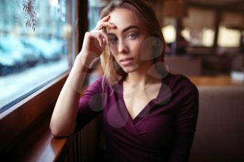 Beauty woman waiting in coffee shop. Young girl in restaurant.