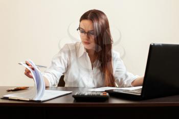 Young woman accountant at workplace concept. Female bookkeeper at the table